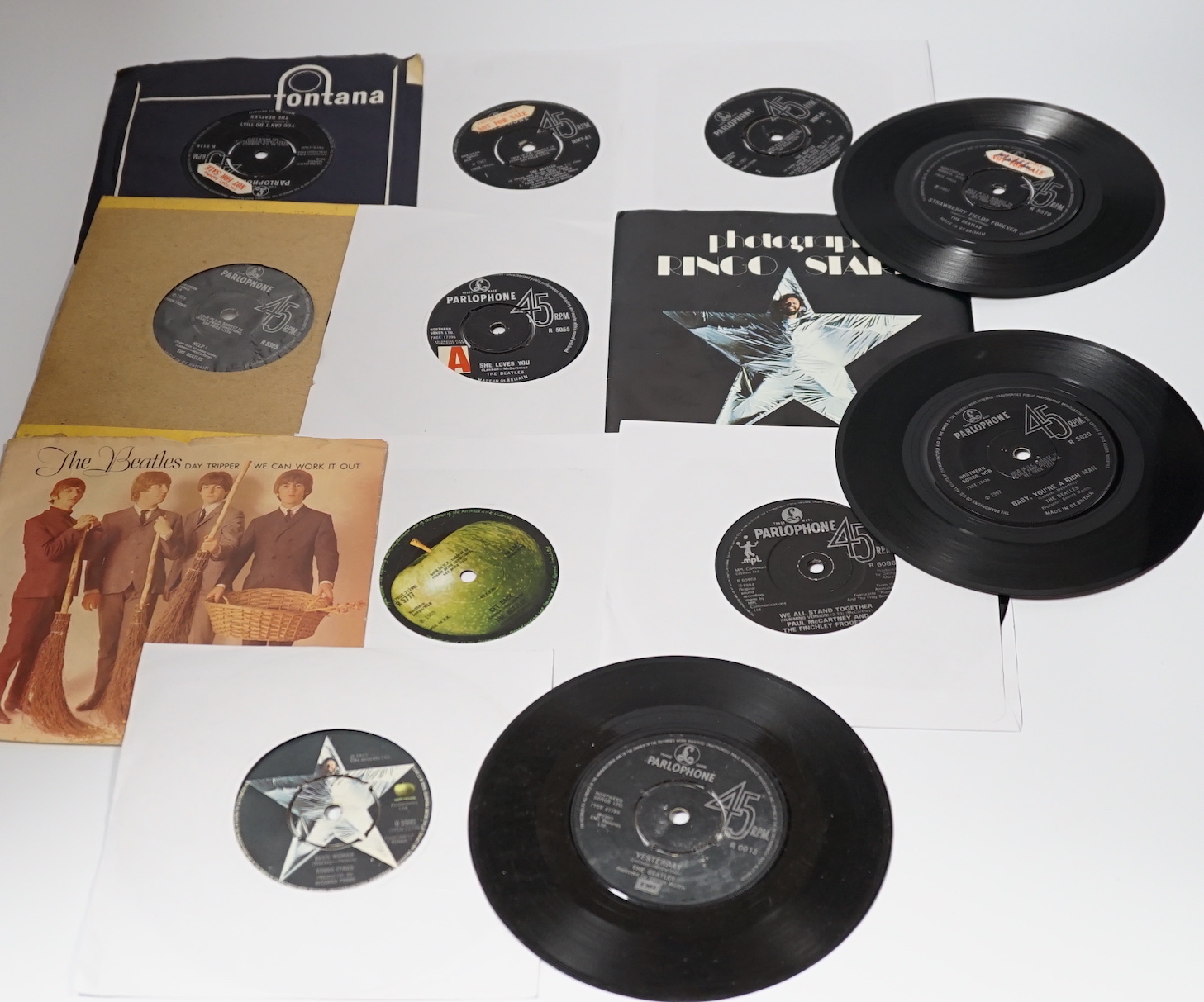 Thirteen The Beatles and related 7 inch singles; eight of which have demo stickers; ‘Factory Sample Not For Sale’